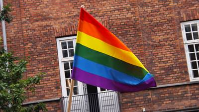 Billede af et regnbueflag, LGBT, foran bygning